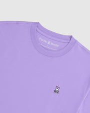 This luxurious Pima cotton tee, titled "MENS CLASSIC CREW NECK TEE - B6U014Z1PC" by Psycho Bunny, is designed in lavender with an embroidered bunny skull and crossbones logo on the front. The inside label near the collar displays the "Psycho Bunny" brand name.