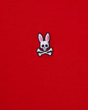 The MENS CLASSIC V NECK TEE - B6U100CRPC from Psycho Bunny showcases a red fabric made of soft Pima cotton and features the brand's signature logo: a white skull and crossbones with playful pink bunny ears.
