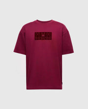 The Psycho Bunny Men's Romeo Heavy Weight Relaxed Fit Tee (B6U110E200) in maroon features a rectangular graphic with three stylized black bunny designs across the chest. This T-shirt combines style with a relaxed fit, ensuring comfort for casual wear. Presented against a plain gray background, it seamlessly blends fashion and comfort.