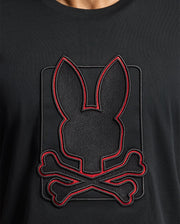 The Psycho Bunny MENS PIERCE EMBROIDERED GRAPHIC TEE - B6U115E200 features a distinctive bunny silhouette above crossed bones, outlined in red, crafted from durable black Pima cotton.