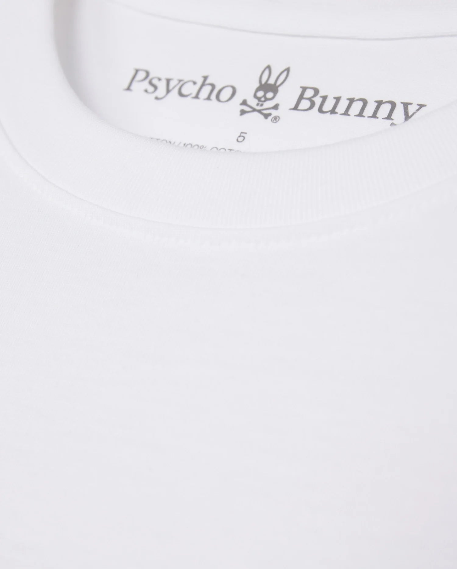 Close-up of a MENS MAYBROOK GRAPHIC TEE - B6U130B2TS label featuring the "Psycho Bunny" logo with a stylized rabbit graphic above the text.