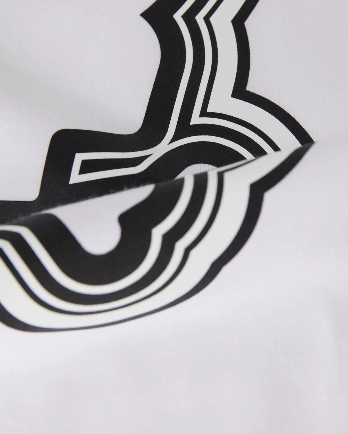 Close-up of a white Pima cotton fabric with a bold, black abstract design, featuring smooth curves and sharp angles. The focus is on the texture of the material and the contrast of the design in the Psycho Bunny MENS MAYBROOK GRAPHIC TEE - B6U130B2TS.