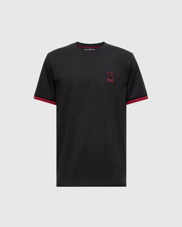The Psycho Bunny MENS PIERCE FASHION TEE - B6U140E200 is crafted from Pima cotton and showcases red accents on the sleeve edges along with an embroidered Bunny patch emblem on the chest, set against a plain gray background.