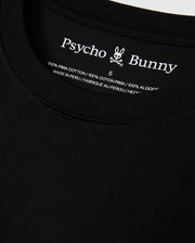 Close-up of the MENS HAWAII CITY TEE by Psycho Bunny, highlighting the black label inside the collar featuring its iconic logo and text indicating it's crafted from 100% Pima cotton, made in Peru.