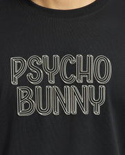 A close-up of the Mens Monarc Wordmark Graphic Tee - B6U210E200 from Psycho Bunny showcases bold white outlined text reading "PSYCHO BUNNY" in a stylized, three-dimensional font against a black backdrop. Made from 100% Pima cotton, it provides a regular fit that ensures ultimate comfort and style.