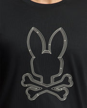 The Psycho Bunny Men's Monarc Front Bunny Graphic Tee (B6U211E200) is made from 100% Pima cotton and showcases a minimalist skull and crossbones motif with a rabbit's head above two crossed bones. This eye-catching design is set against the black T-shirt, enhanced by a rib knit crewneck for increased comfort and style.