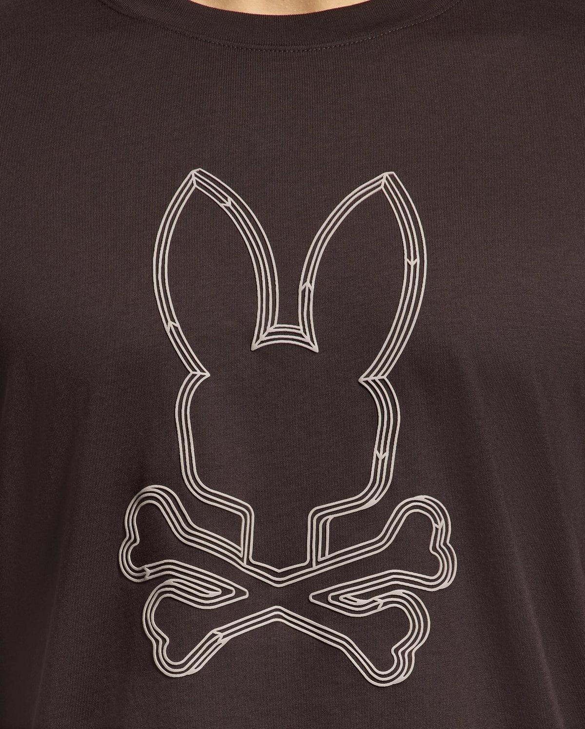Introducing the Psycho Bunny men's graphic tee: the MENS MONARC FRONT BUNNY GRAPHIC TEE - B6U211E200 in black Pima cotton, featuring a raised-printed bunny head above two crossed bones, expertly blending comfort with edgy style.