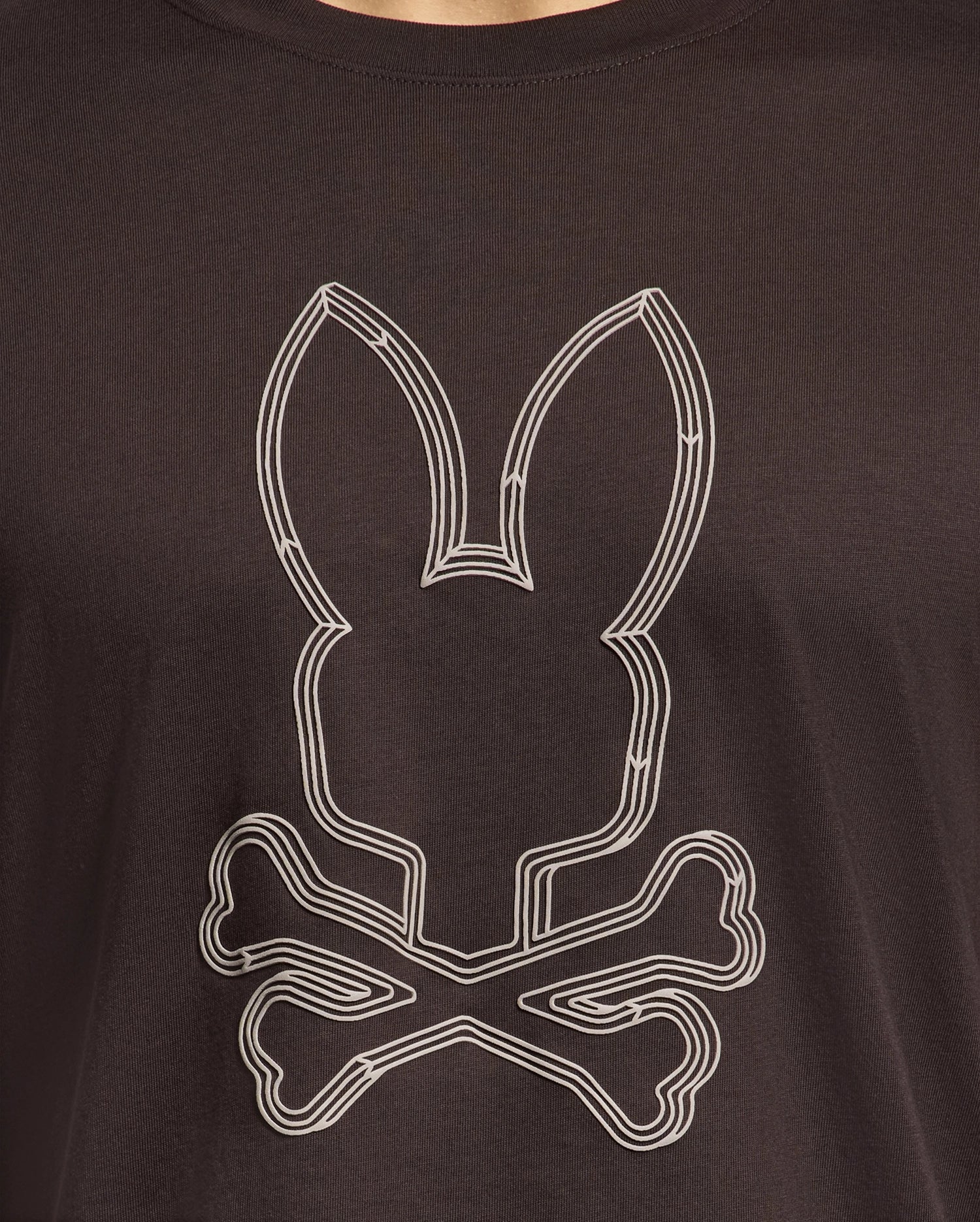 Introducing the Psycho Bunny men's graphic tee: the MENS MONARC FRONT BUNNY GRAPHIC TEE - B6U211E200 in black Pima cotton, featuring a raised-printed bunny head above two crossed bones, expertly blending comfort with edgy style.