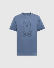 The Psycho Bunny MENS MONARC FRONT BUNNY GRAPHIC TEE - B6U211E200 is a blue Pima cotton T-shirt featuring a minimalist rabbit head design above crossed bones in a darker hue, embodying simplicity and casual style ideal for everyday wear.