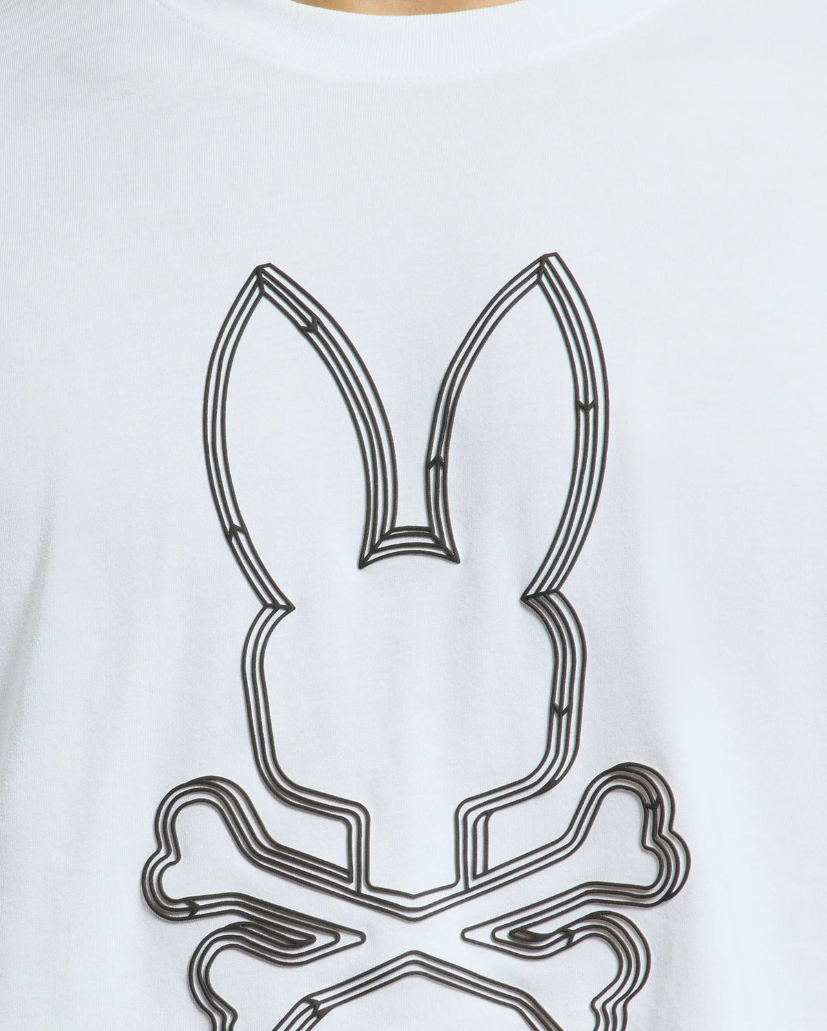 This close-up showcases the Mens Monarc Front Bunny Graphic Tee (B6U211E200) from Psycho Bunny. Made in Peru using 100% Pima cotton, this tee features an abstract bunny with ears outlined in black lines set above a skull and crossbones motif, offering an avant-garde twist to your style.