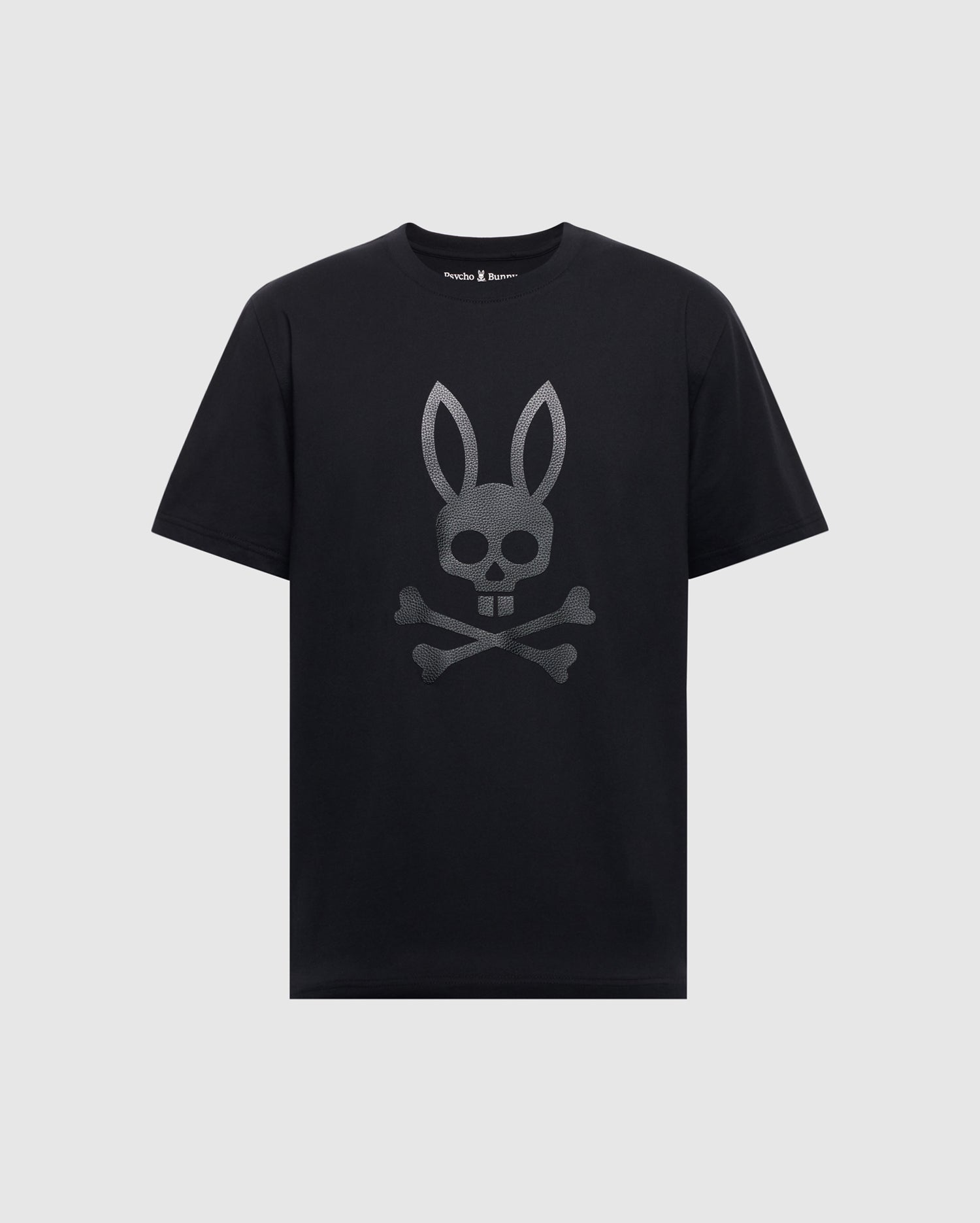 Psycho Bunny’s MENS PAYSON LEATHER PRINT GRAPHIC TEE - B6U213E200 is a black Pima cotton jersey tee with a silver skull featuring bunny ears and crossbones design on the front.
