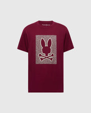 The MENS ROCKTON GRAPHIC TEE - B6U247C200 by Psycho Bunny is a maroon Pima cotton shirt featuring a stylized bunny head with long ears and crossbones on a patterned rectangular backdrop, blending comfort and style seamlessly.