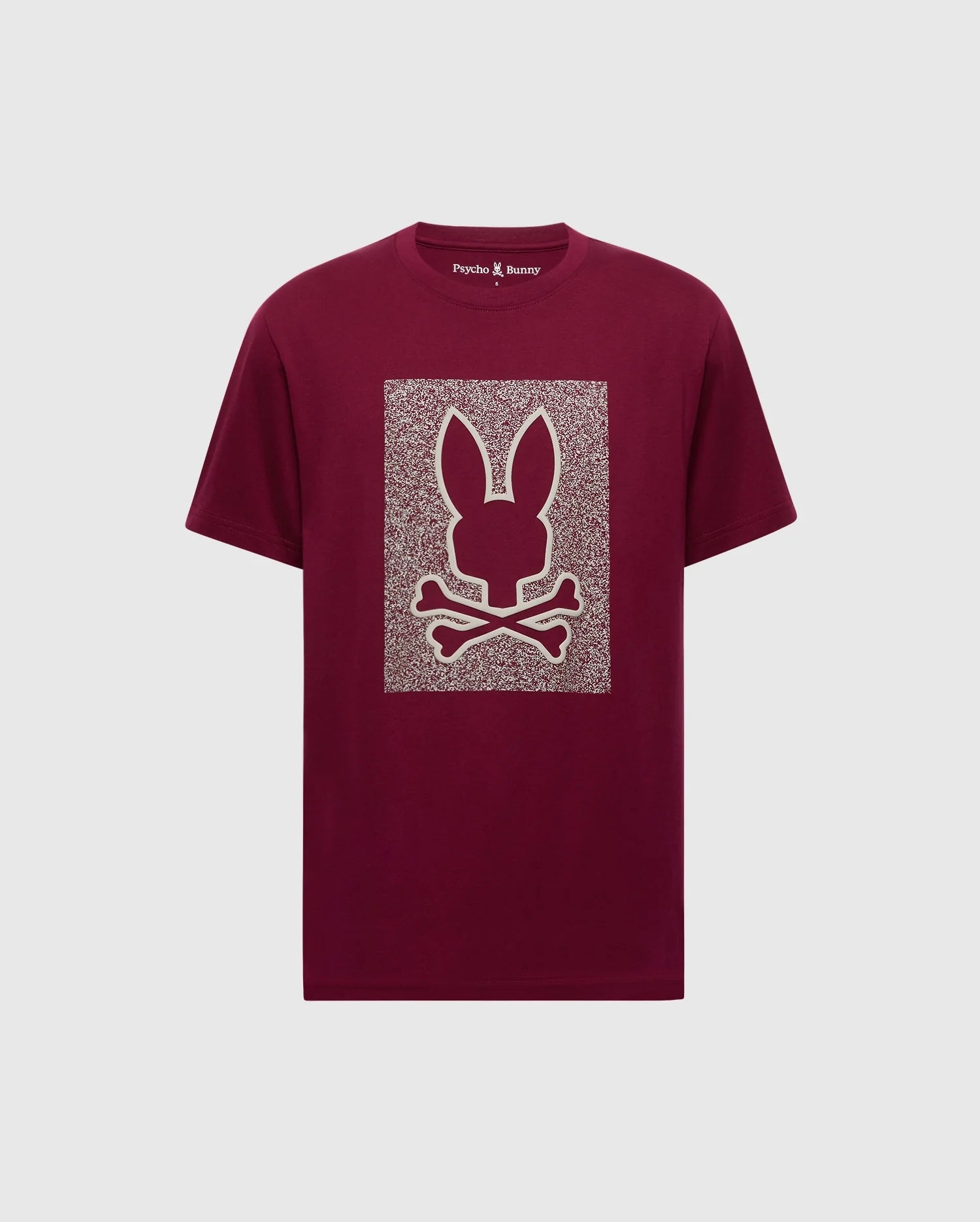 The MENS ROCKTON GRAPHIC TEE - B6U247C200 by Psycho Bunny is a maroon Pima cotton shirt featuring a stylized bunny head with long ears and crossbones on a patterned rectangular backdrop, blending comfort and style seamlessly.