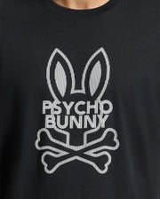 A close-up of the Psycho Bunny Men's Dumon Graphic Tee - B6U271E200, a black t-shirt made from premium Peruvian Pima Cotton, showcases a white stylized bunny with tall ears and crossbones beneath it, along with the "Psycho Bunny" text seamlessly incorporated into the design.