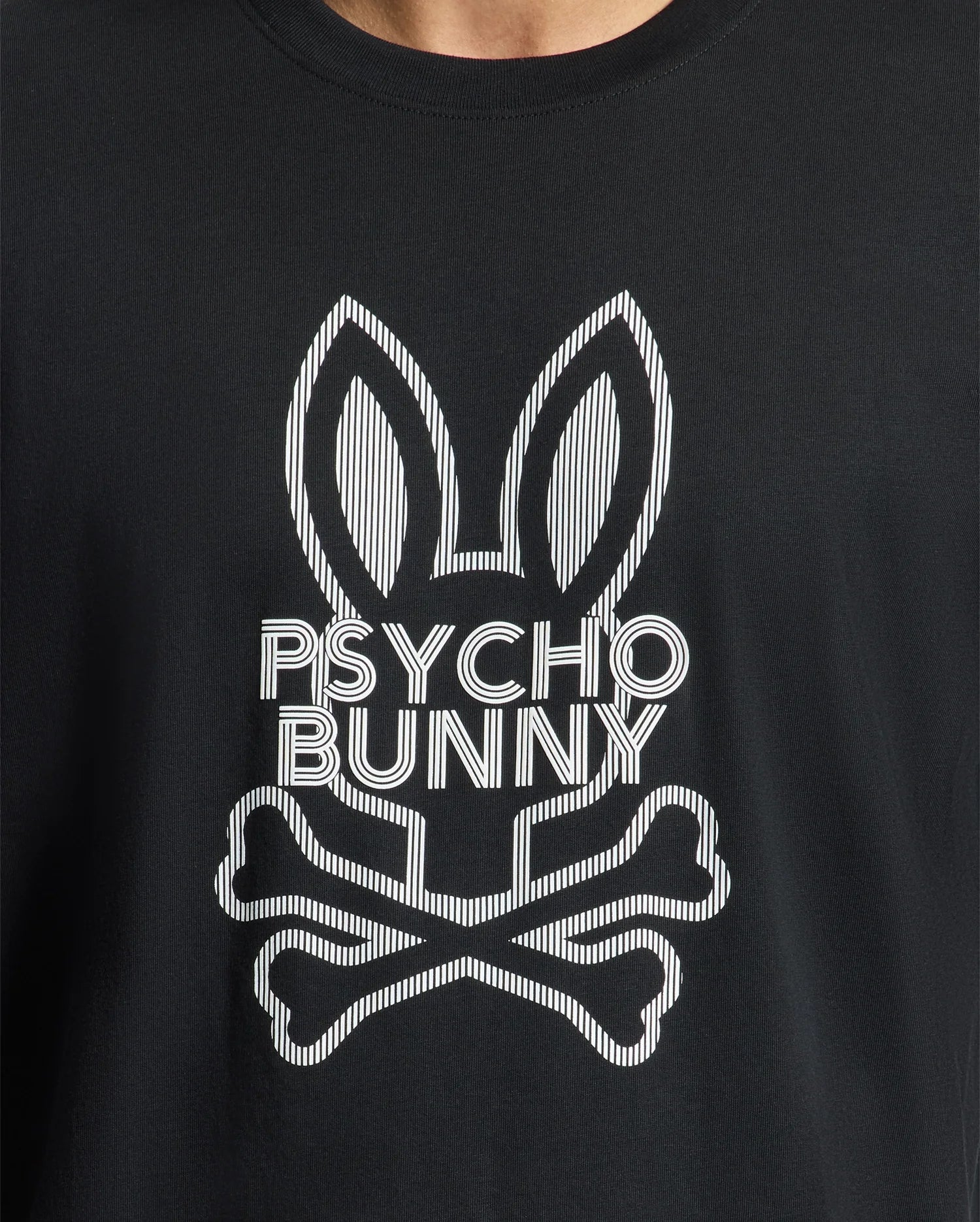 A close-up of the Psycho Bunny Men's Dumon Graphic Tee - B6U271E200, a black t-shirt made from premium Peruvian Pima Cotton, showcases a white stylized bunny with tall ears and crossbones beneath it, along with the "Psycho Bunny" text seamlessly incorporated into the design.