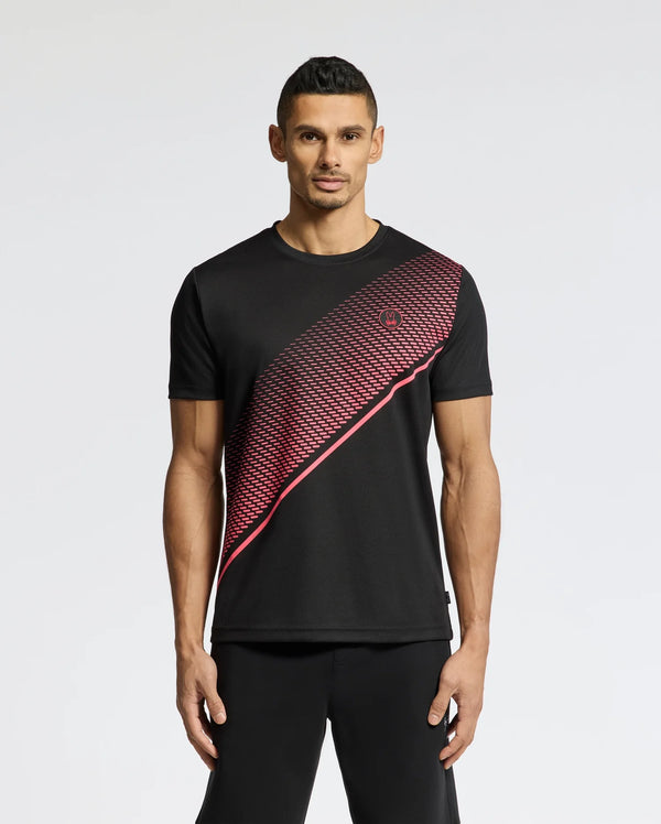 A man exudes confidence in the Psycho Bunny MENS MACK SPORT TEE - B6U335E200, showcasing premium Peruvian quality with a red diagonal pattern. With short black hair and matching pants, he's set for any activity with its quick-dry, moisture-wicking fabric against a plain white background.