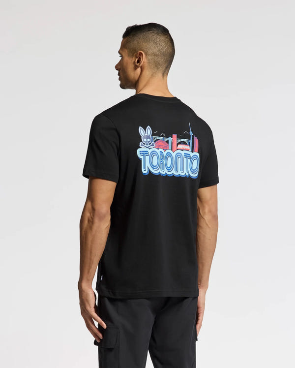 A person wears the Psycho Bunny MENS TORONTO TEE - B6U383F200, made of soft Pima cotton. It has a vibrant hometown hero graphic with "Toronto," a rabbit, and city landmarks on the back, perfectly showcased as they face away.