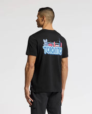 A person wears the Psycho Bunny MENS TORONTO TEE - B6U383F200, made of soft Pima cotton. It has a vibrant hometown hero graphic with "Toronto," a rabbit, and city landmarks on the back, perfectly showcased as they face away.