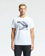 A man in a white Psycho Bunny MENS DEAN PHOTO REAL TEE - B6U390E200, showcasing urban geometric black-and-white staircase designs, stands against a plain backdrop. Made from soft Pima cotton, he has short hair and gazes directly at the camera.
