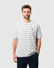 Front view of a male model wearing the mens pima cotton alton stripe heavy weight tee with one hand in his pocket 