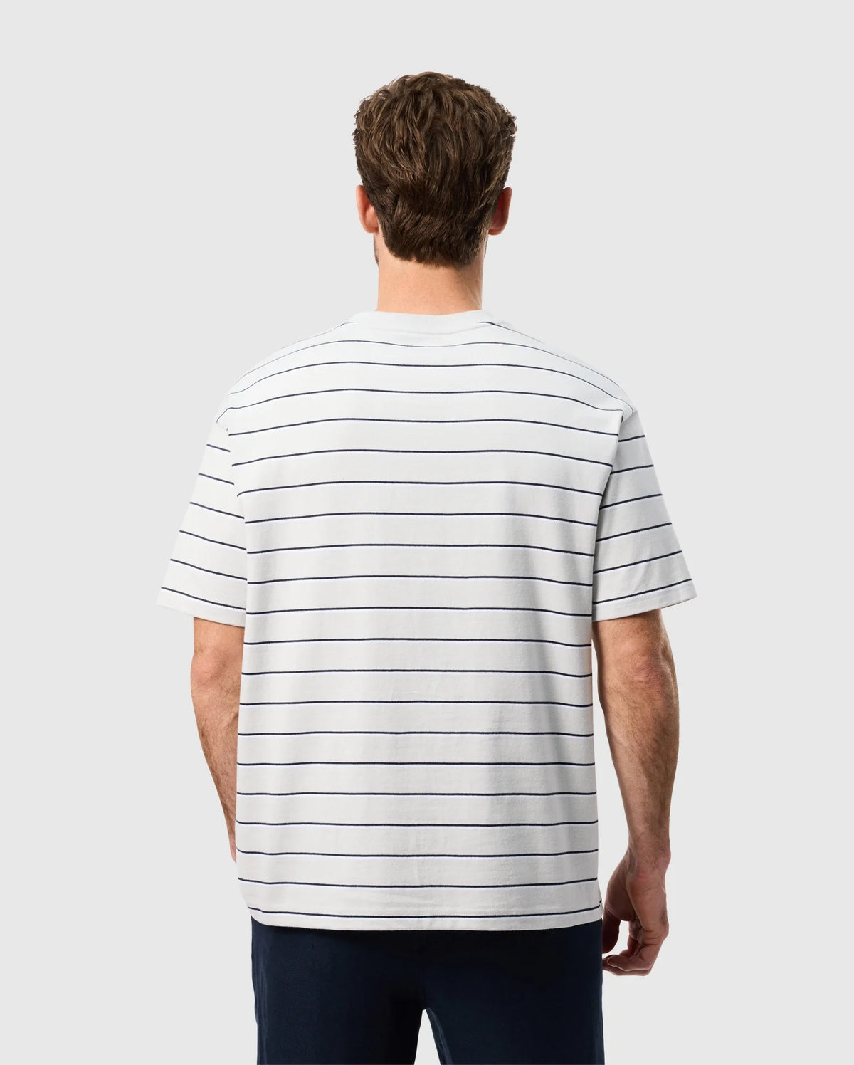 Back view of a male model wearing the mens pima cotton alton stripe heavy weight tee in pearl
