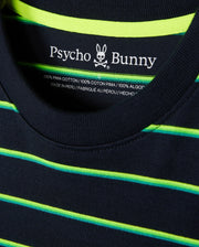 Close-up of a navy blue MENS ALTON STRIPE OVERSIZED TEE - B6U409C200 featuring 90s-inspired two-tone neon yellow and green horizontal stripes. The relaxed fit shirt's label inside the collar shows "Psycho Bunny" with a bunny skull logo, indicating it’s made of 100% Pima cotton and crafted in Peru.