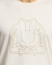 The Psycho Bunny MENS MELBOURNE GRAPHIC TEE - B6U410F200, made from luxurious Peruvian Pima cotton, features a white t-shirt with an embossed bunny silhouette above crossed bones and swirling "PSYCHO BUNNY" text, offering an eco-friendly style.