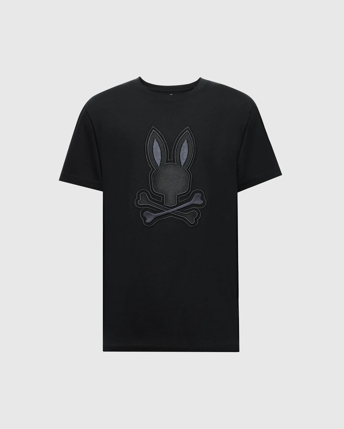 The Psycho Bunny MENS NEW CASTLE GRAPHIC TEE (B6U415F200) features a stylized embroidered bunny head with crossbones on a black Pima cotton T-shirt against a plain white background.