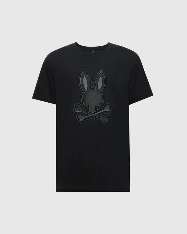 The Psycho Bunny MENS NEW CASTLE GRAPHIC TEE (B6U415F200) features a stylized embroidered bunny head with crossbones on a black Pima cotton T-shirt against a plain white background.