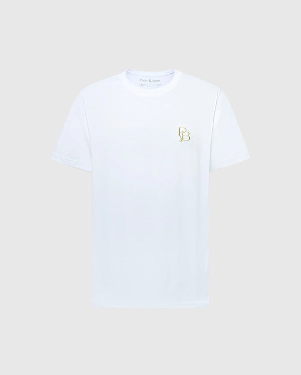 The MENS NICHOLSON PB CHEST GRAPHIC TEE by Psycho Bunny features a small gold "B B" logo on the left chest. Made from premium Pima cotton, this stylish white tee stands out against a gray background.