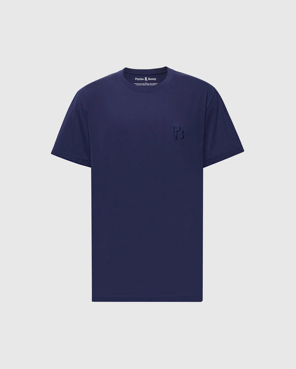 The Psycho Bunny MENS NICHOLSON PB CHEST GRAPHIC TEE - B6U416F200 is a plain navy blue T-shirt made of soft Pima cotton with short sleeves and a small embroidered logo on the left chest, set against a light gray background.