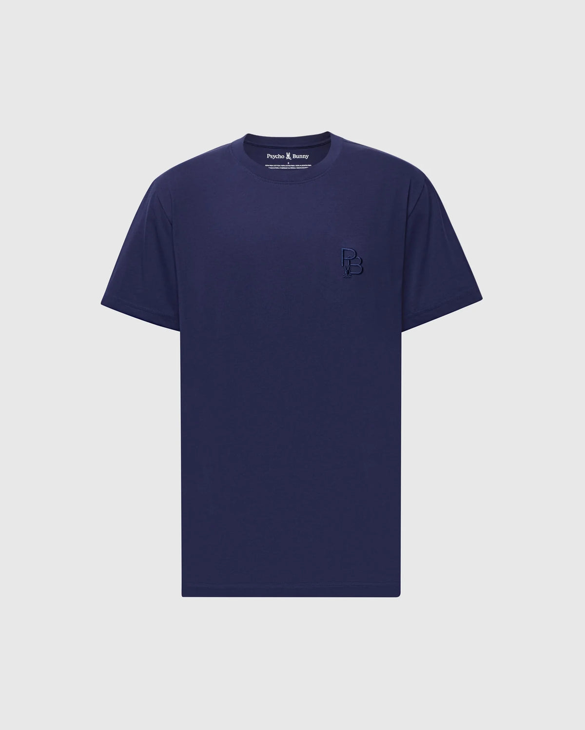 The Psycho Bunny MENS NICHOLSON PB CHEST GRAPHIC TEE - B6U416F200 is a plain navy blue T-shirt made of soft Pima cotton with short sleeves and a small embroidered logo on the left chest, set against a light gray background.