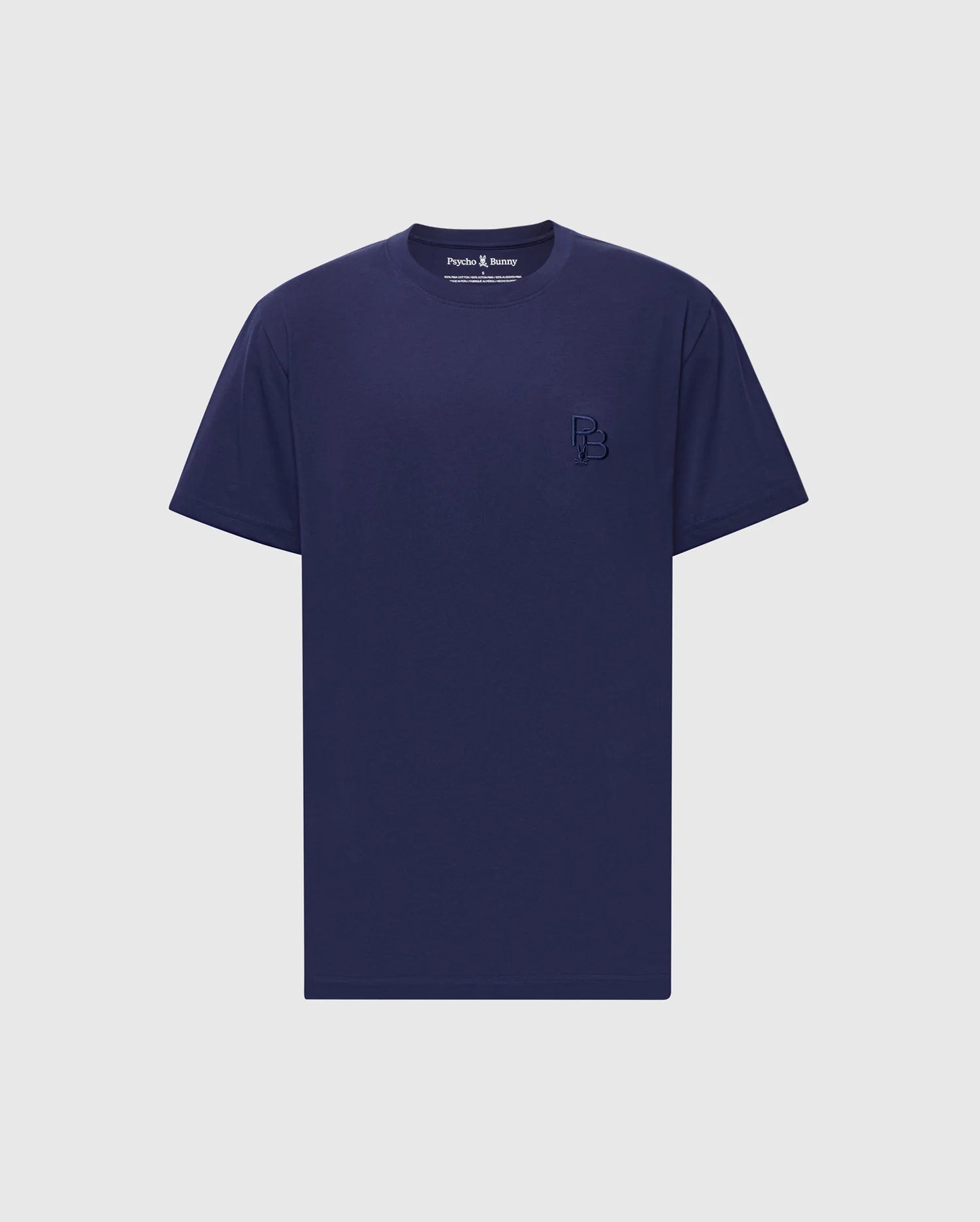The Psycho Bunny MENS NICHOLSON PB CHEST GRAPHIC TEE - B6U416F200 is a plain navy blue T-shirt made of soft Pima cotton with short sleeves and a small embroidered logo on the left chest, set against a light gray background.