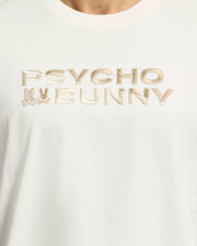The Men's Berni Embroidered Wordmark Graphic Tee in Pima cotton features "Psycho Bunny" embroidered in beige, with two subtle bunny head logos alongside the text on the left side.