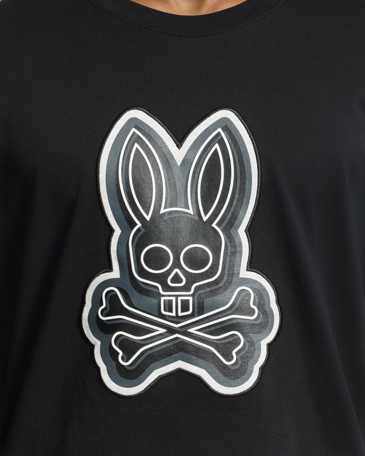 The Psycho Bunny MENS SYDNEY GRAPHIC TEE - B6U508F200 is a black Pima cotton shirt with a bold cartoonish rabbit skull and crossbones graphic in white, creating a striking contrast.