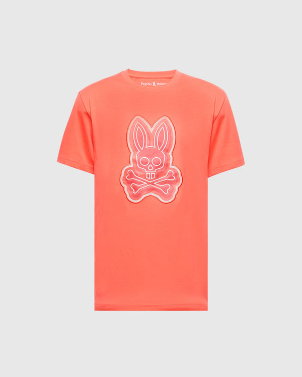 The MENS SYDNEY GRAPHIC TEE - B6U508F200 by Psycho Bunny is a coral-colored, soft Pima cotton T-shirt featuring a glow-in-the-dark bunny with crossed bones graphic on the front.