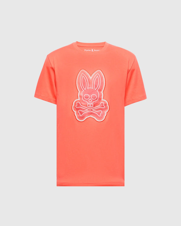 The MENS SYDNEY GRAPHIC TEE - B6U508F200 by Psycho Bunny is a coral-colored, soft Pima cotton T-shirt featuring a glow-in-the-dark bunny with crossed bones graphic on the front.