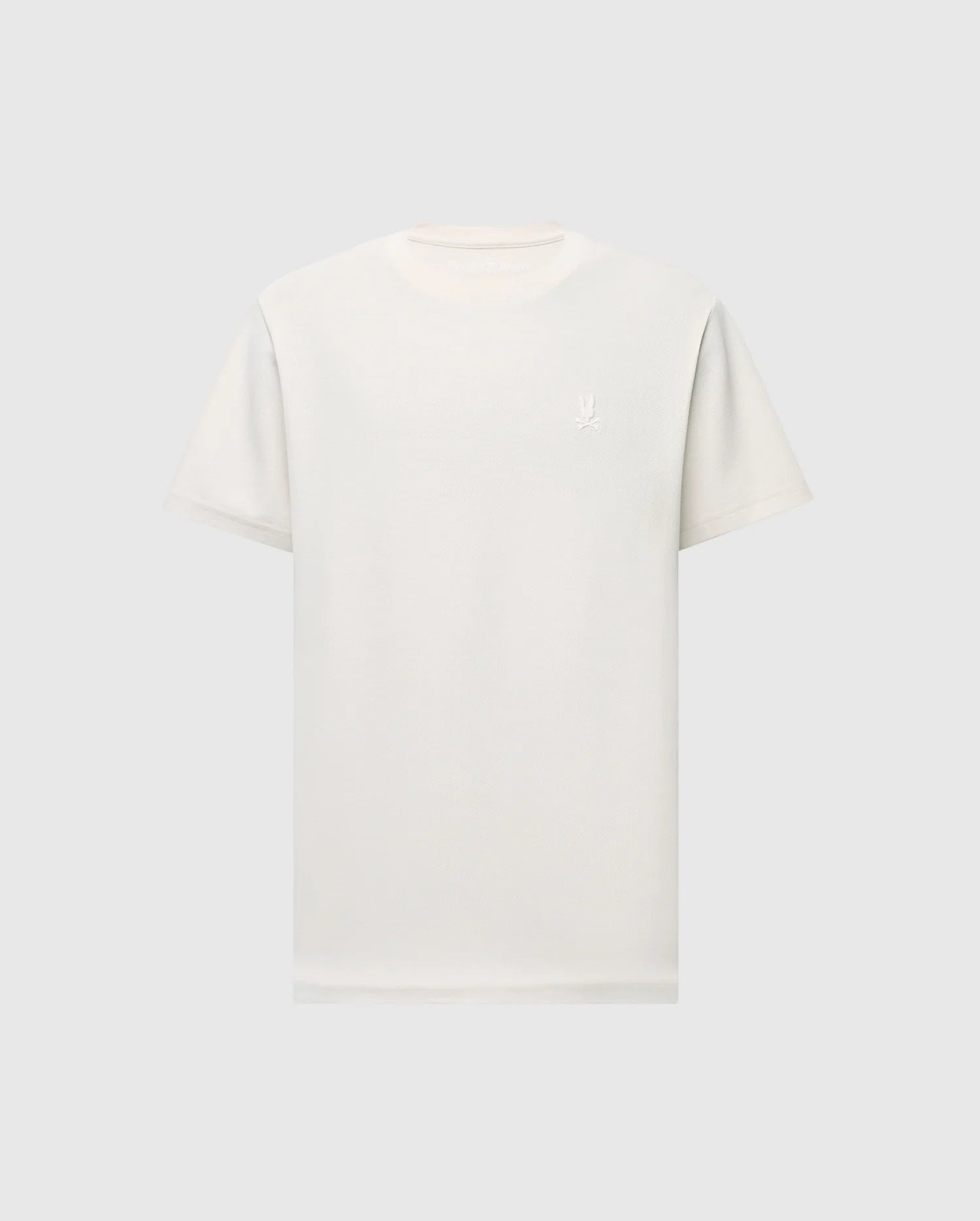 The MENS TAYLOR PIQUE TEE by Psycho Bunny is a plain white, regular fit shirt, made from lightweight Pima cotton with a round neckline and short sleeves. It displays a small, subtle embroidered chest bunny logo on the upper chest and is set against a light gray background.