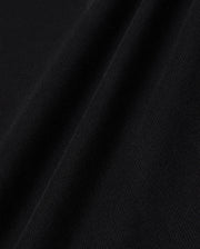 Close-up view of black Psycho Bunny MENS WINDCREST HEAVY WEIGHT TEE - B6U593C200 texture showing detailed weave patterns and soft focus on fabric ridges.