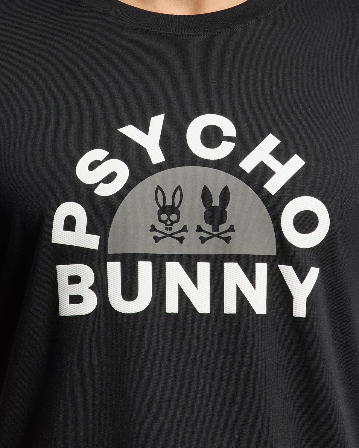 Discover the Psycho Bunny Men's Goldie Graphic Tee - B6U606F200: a black Peruvian Pima cotton shirt with "Psycho Bunny" in white text above two unique bunny skulls featuring ears and crossbones.
