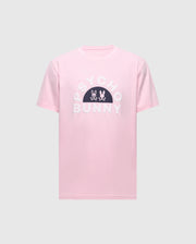 Introducing the MENS GOLDIE GRAPHIC TEE by Psycho Bunny: A pink Pima Cotton tee with "PSYCHO BUNNY" in bold white letters and a black semi-circle displaying a striking Bunny Graphic with crossbones.