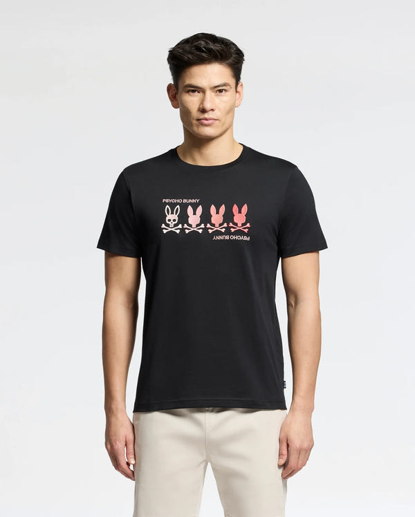 Someone stands against a plain background wearing a Psycho Bunny MENS OCEANIA EMBROIDERED GRAPHIC TEE. The black Pima Cotton shirt features an embroidered bunny graphic with four gradient bunnies (white to pink), "RHYTHM BUNNY" above, and "ANRHY OHOMAJ" below, exuding retro vibes.