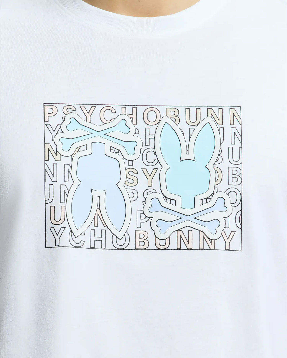 A close-up of the Psycho Bunny MENS GOLD COAST GRAPHIC TEE, B6U631F200, shows a light blue bunny with crossbones logo on white Pima cotton. The "PSYCHO BUNNY" text in a grid pattern emphasizes its premium craftsmanship.