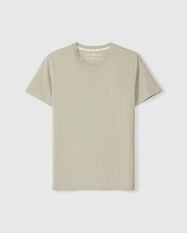 The Pearland tee, a light beige short-sleeved t-shirt crafted from soft Pima cotton, features the Psycho Bunny's small embroidered bunny logo on the upper left side of the chest. The shirt, officially named MENS PEARLAND BACK GRAPHIC TEE - B6U632C200, is displayed against a plain white background.