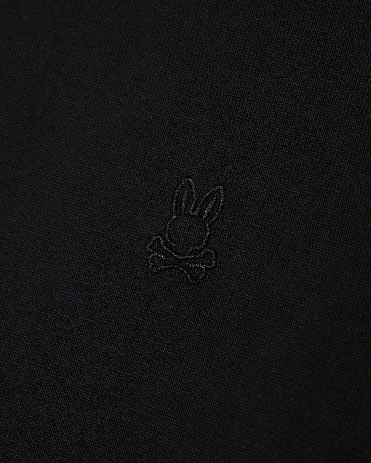 The Psycho Bunny MENS DUKE OVERSIZED TEE - B6U742D200 is a relaxed fit Pima cotton tee in black, featuring a small embroidered emblem of a rabbit's head with crossbones underneath in matching black thread.