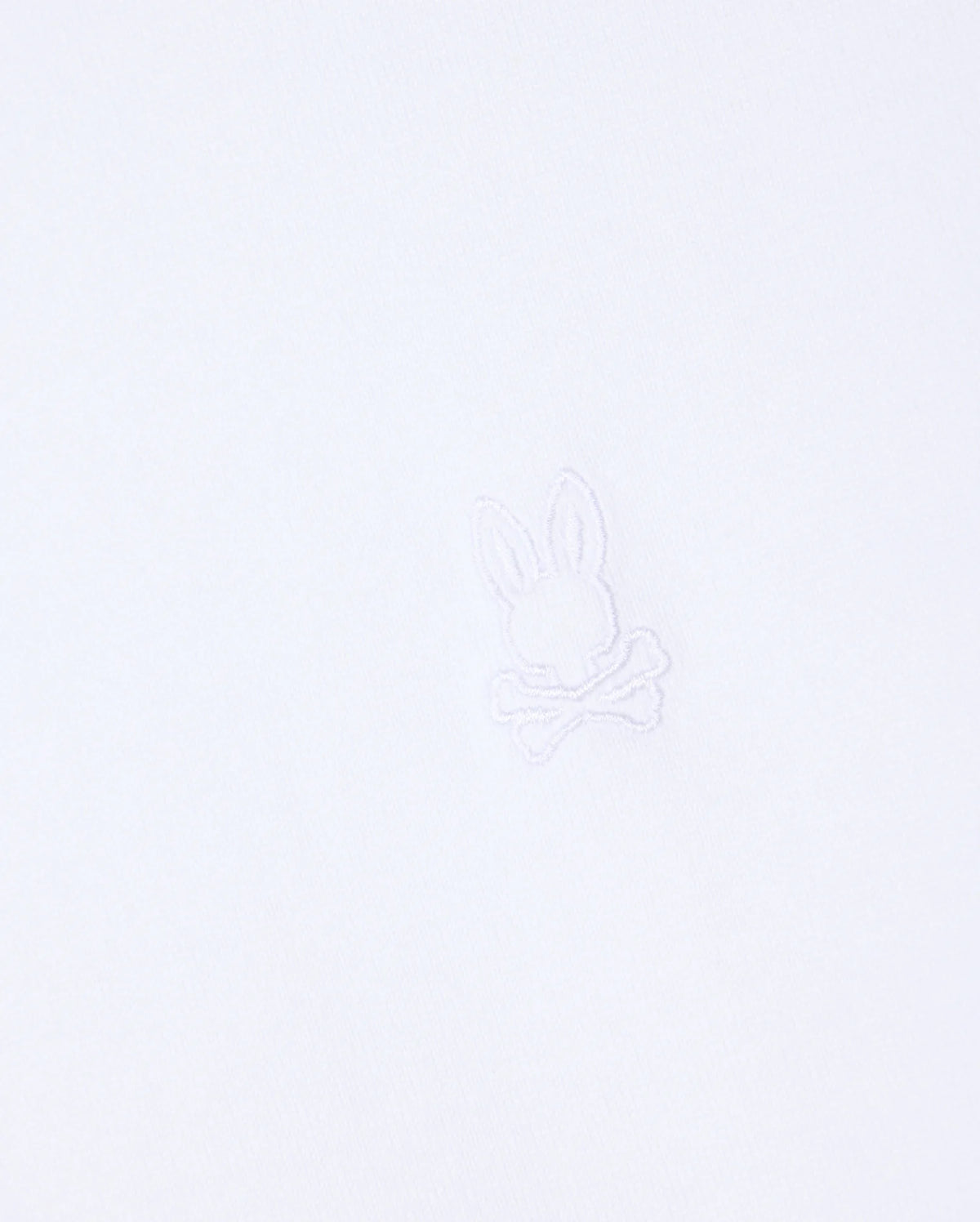 The MENS DUKE OVERSIZED TEE - B6U742D200 by Psycho Bunny is crafted from heavyweight Pima cotton and features a subtle, minimalist embroidered logo in the center, showcasing a bunny head above crossed bones. The matching white embroidery seamlessly blends with the fabric, providing a relaxed fit.