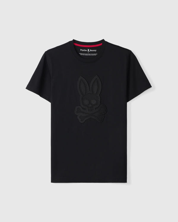 The MENS MALTON GRAPHIC TEE - B6U795D200 by Psycho Bunny is a black short-sleeve T-shirt made from luxurious Pima cotton. It showcases an embossed bunny with crossbones design on the front, featuring a contrasting red lining on the neckline and a small "Psycho Bunny" tag. Made in Peru, this stylish T-shirt is displayed against a plain white background.