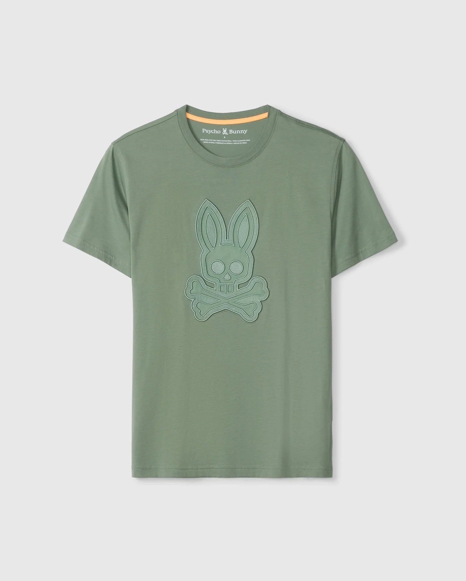 The Psycho Bunny MENS MALTON GRAPHIC TEE - B6U795D200 is a green short-sleeve shirt made from luxurious Pima cotton, featuring a blue embossed design of a bunny skull and crossbones on the front. This Peruvian-crafted tee boasts a round neckline with a yellow inner neck lining.