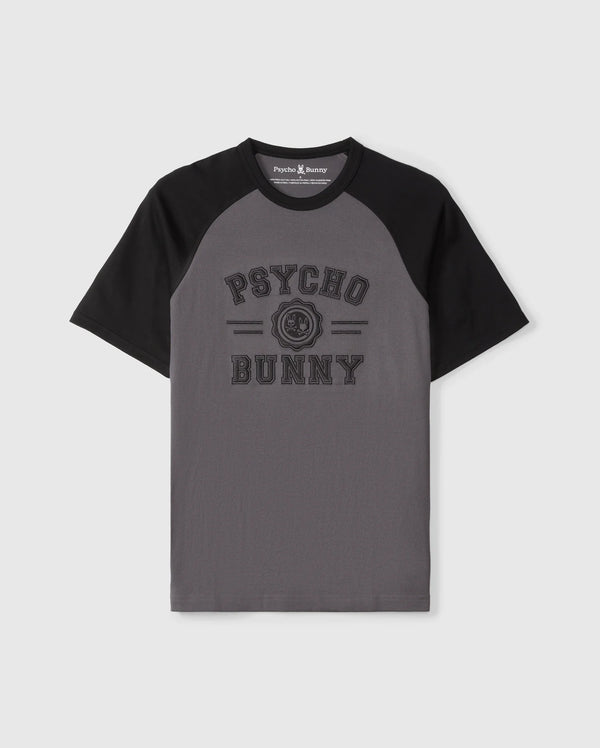The Psycho Bunny MENS LONDON RAGLAN GRAPHIC TEE - B6U896D200 features gray and black short sleeves, "Psycho Bunny" text on the front with a small bunny logo in between. Made of premium Pima cotton, it combines comfort and style perfectly.