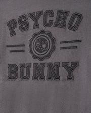 The MENS LONDON RAGLAN GRAPHIC TEE by Psycho Bunny features uppercase "PSYCHO BUNNY" embroidery on gray Pima cotton. A round emblem of two mischievous bunnies takes center stage, framed by subtle horizontal stripes for a unique style.